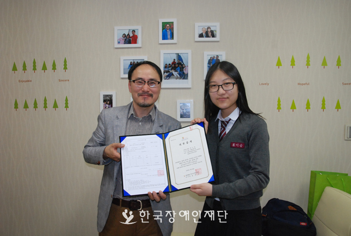 한국장애인재단 사무총장과 최이슬 학생의 기부증서 전달 사진